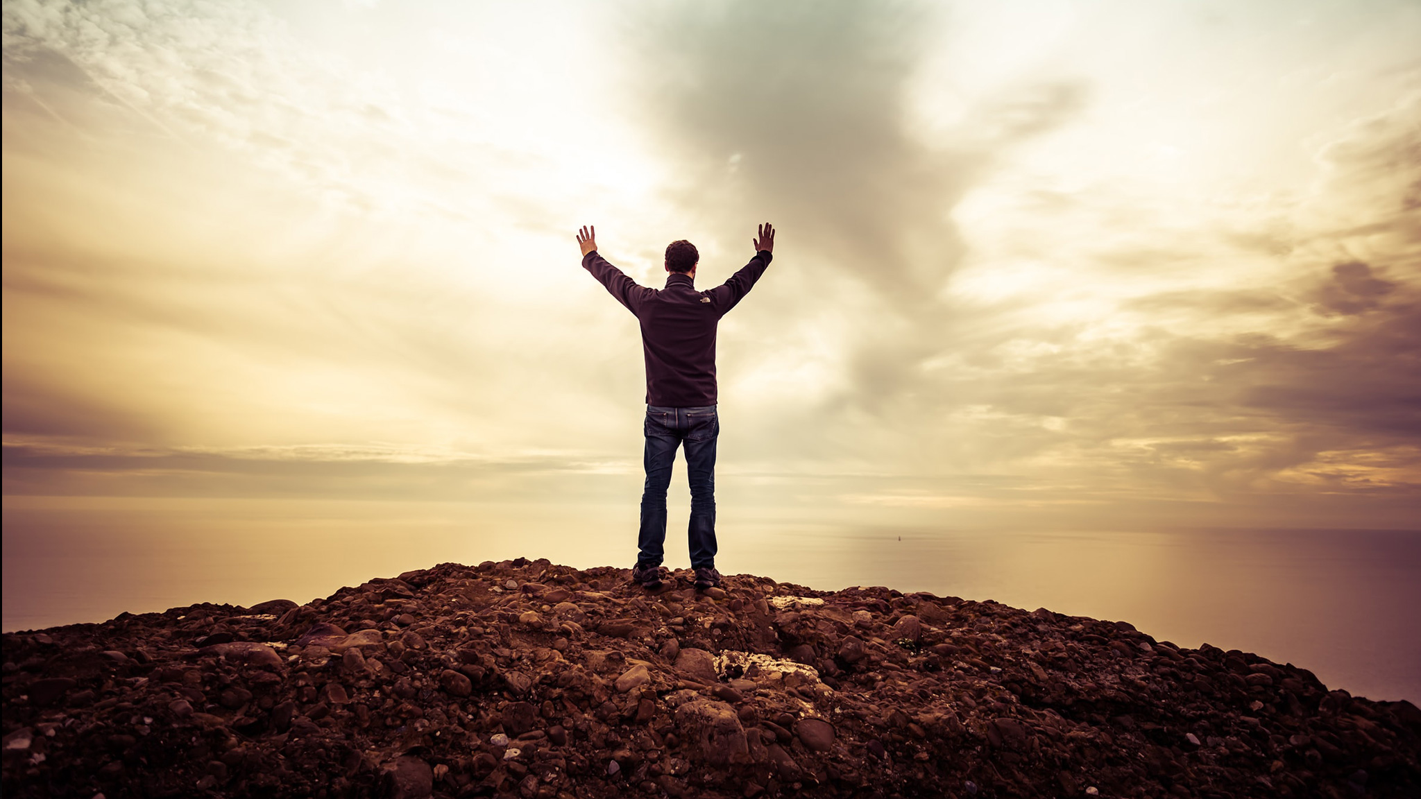 Man Raising Hands Towards Sky